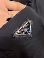 Prada logo patch on dark long-sleeve jacket chest