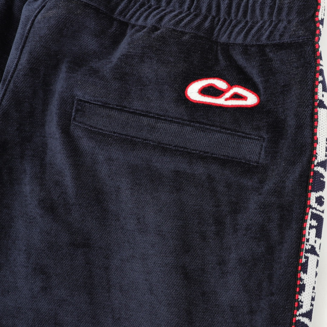 Navy pants with welt pocket and small red-and-white logo patch