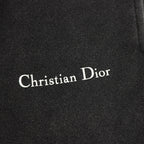 Christian Dior logo on black pants fabric