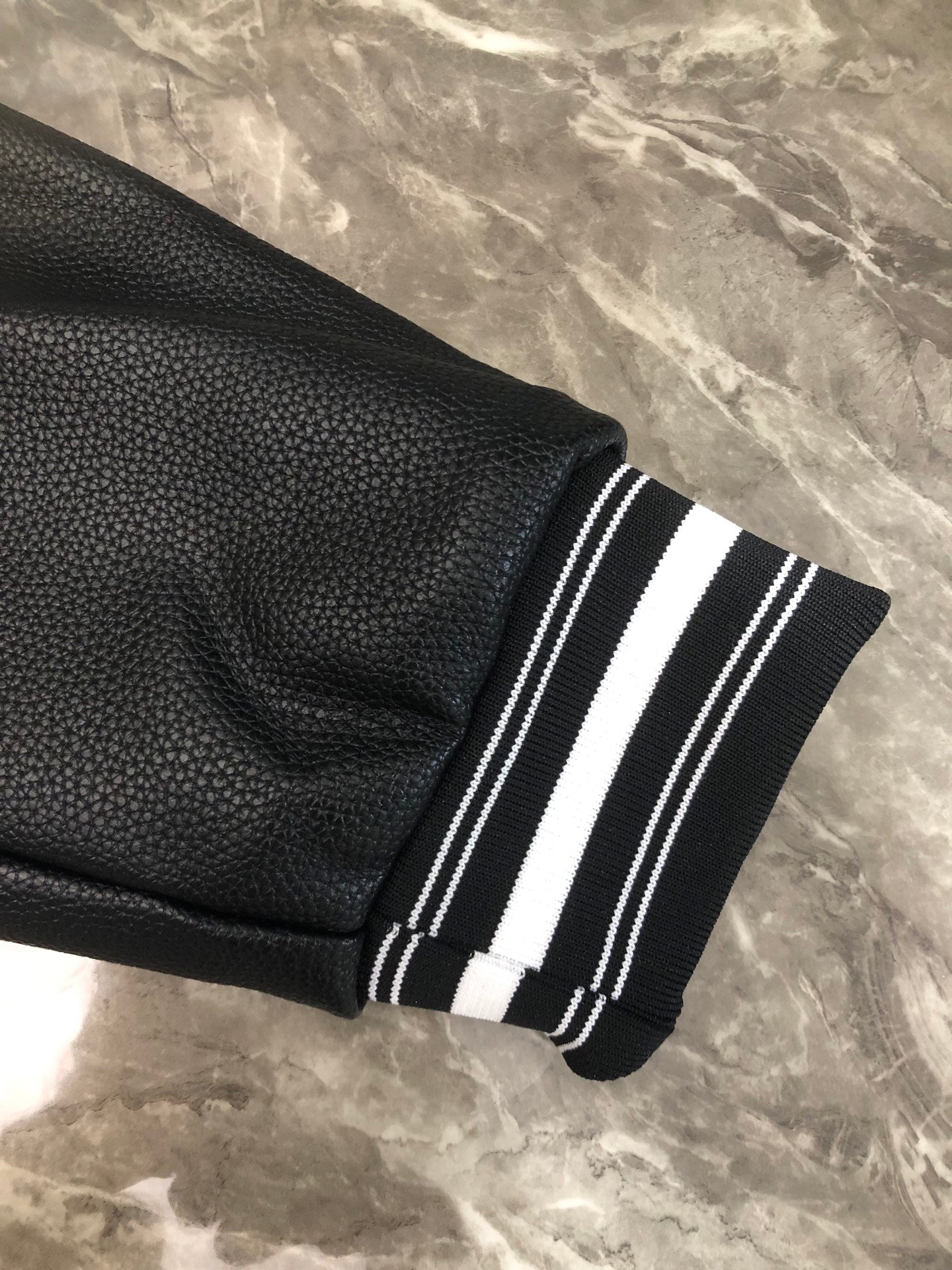 Black sleeve cuff with white triple stripe ribbing