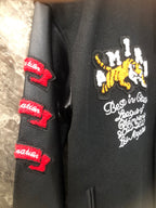 Black sleeve with embroidered patches and red logo stripe accents