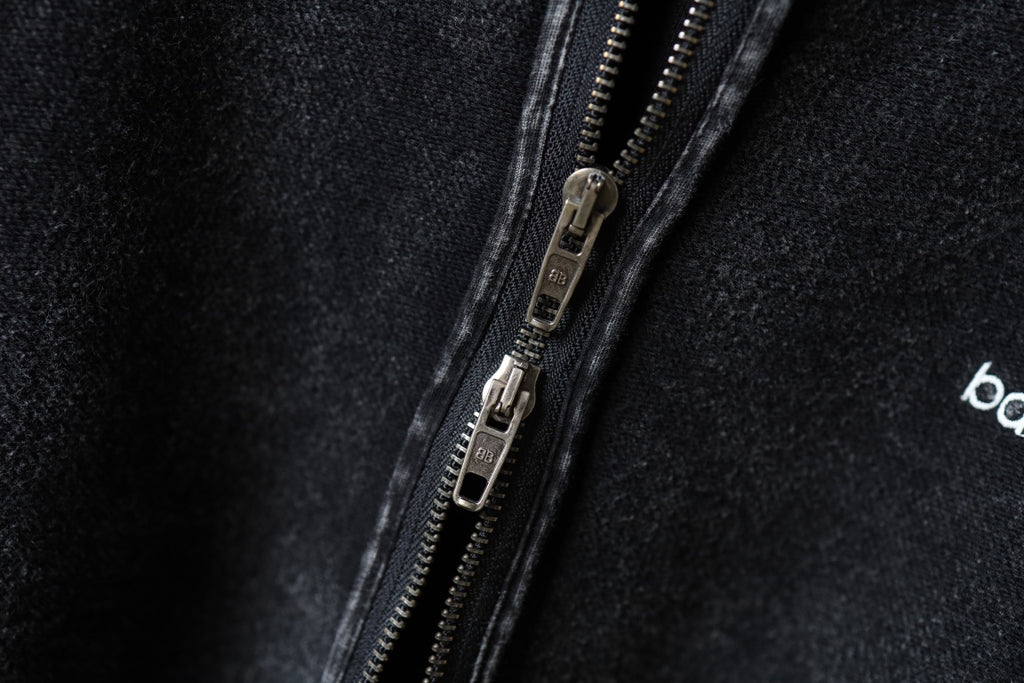 Dark hoodie zipper and metal pull detail
