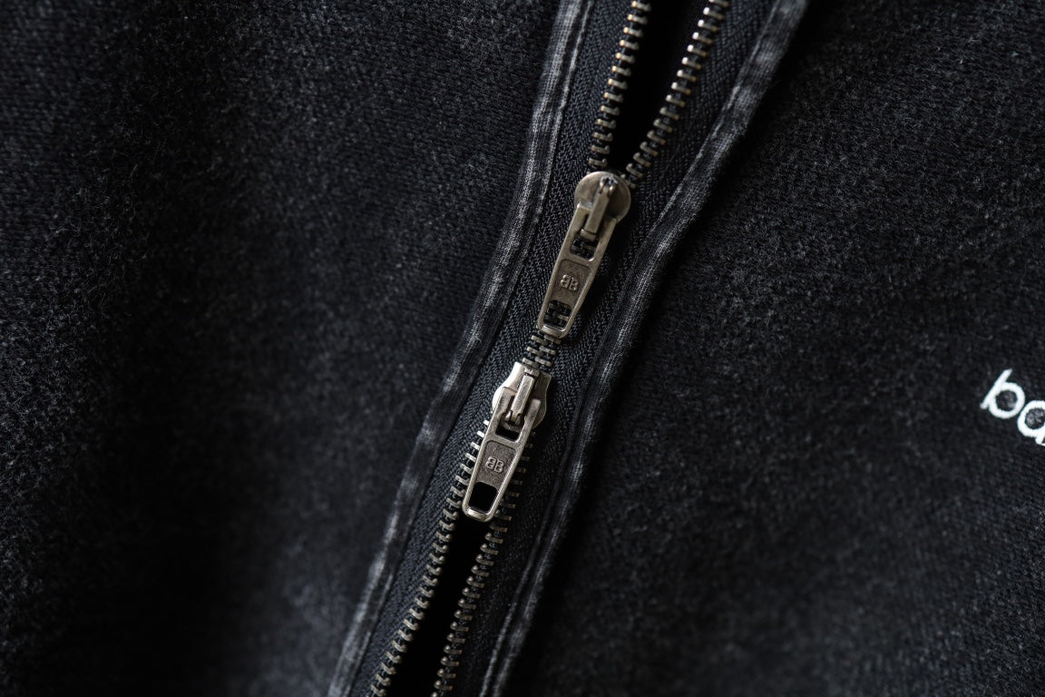 Dark hoodie zipper and metal pull detail