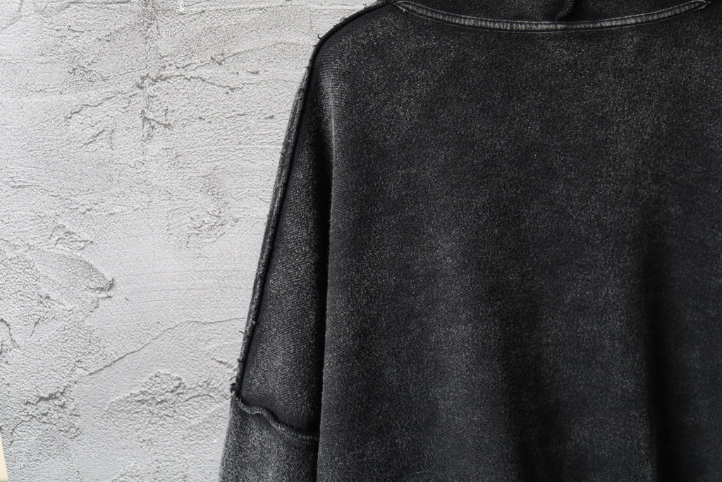 Dark long-sleeve hoodie with stitched shoulder seam