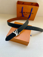 Leather belt with navy strap, tan underside, and gold LV buckle
