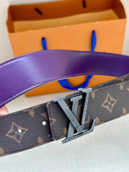 Louis Vuitton belt close-up with dark monogram strap and gold-toned LV buckle.