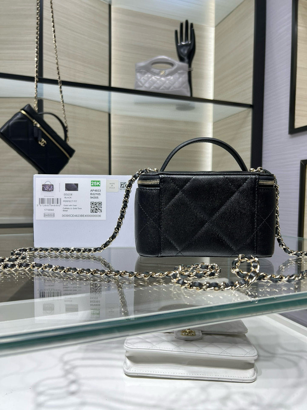 Chanel bag with top handle and chain strap, quilted dark exterior, gold logo