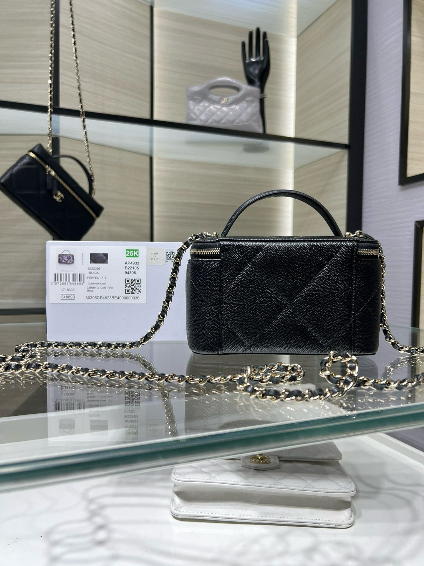 Chanel bag with top handle and chain strap, quilted dark exterior, gold logo