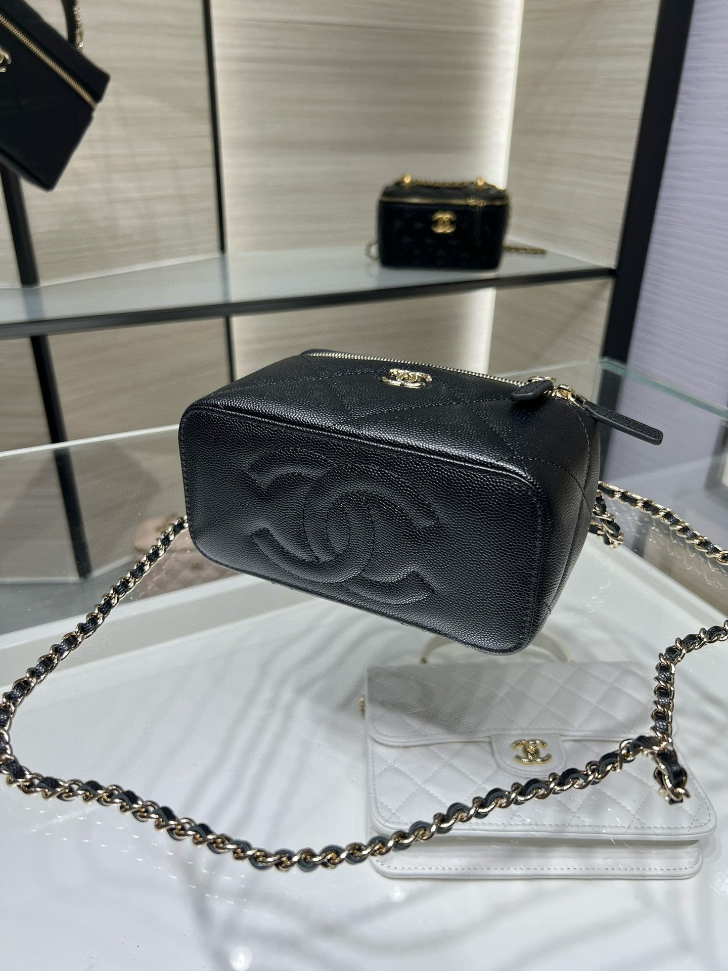 Chanel belt bag with chain strap, embossed logo, dark pebbled leather and zipper