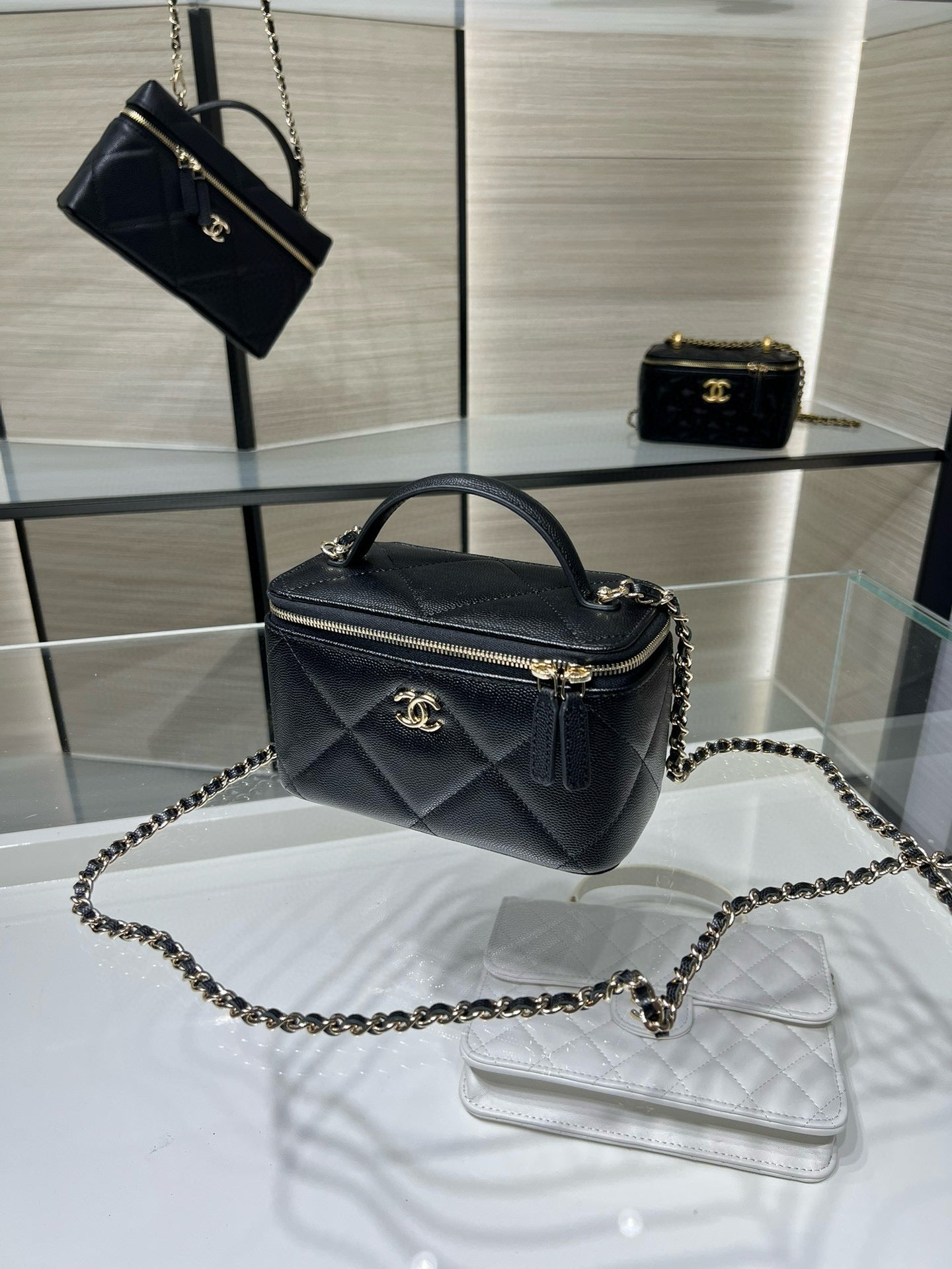 Chanel quilted mini bag with chain strap and top handle, dark leather, gold zipper