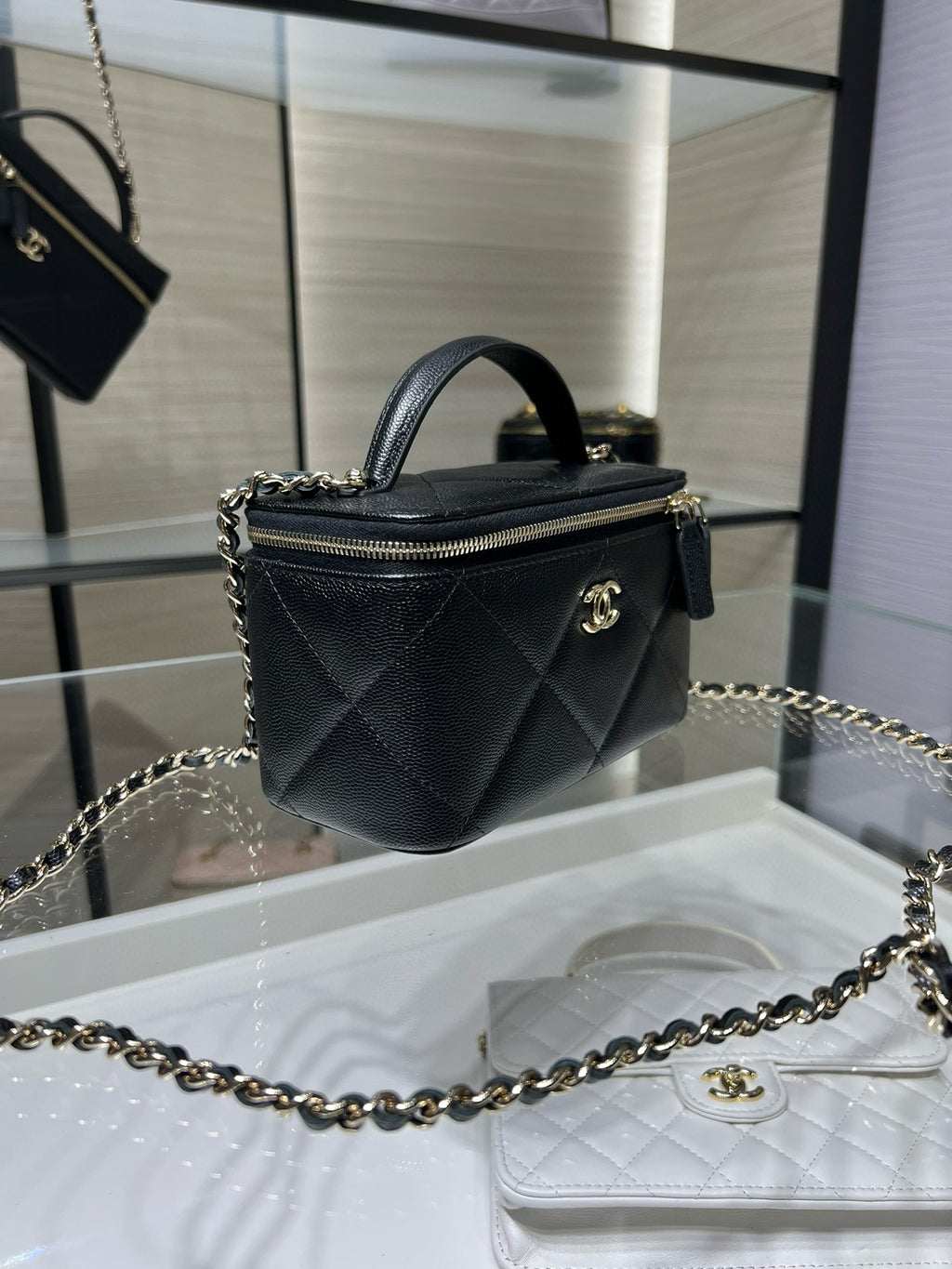 Chanel mini bag with chain strap, quilted dark leather, gold CC clasp and handle