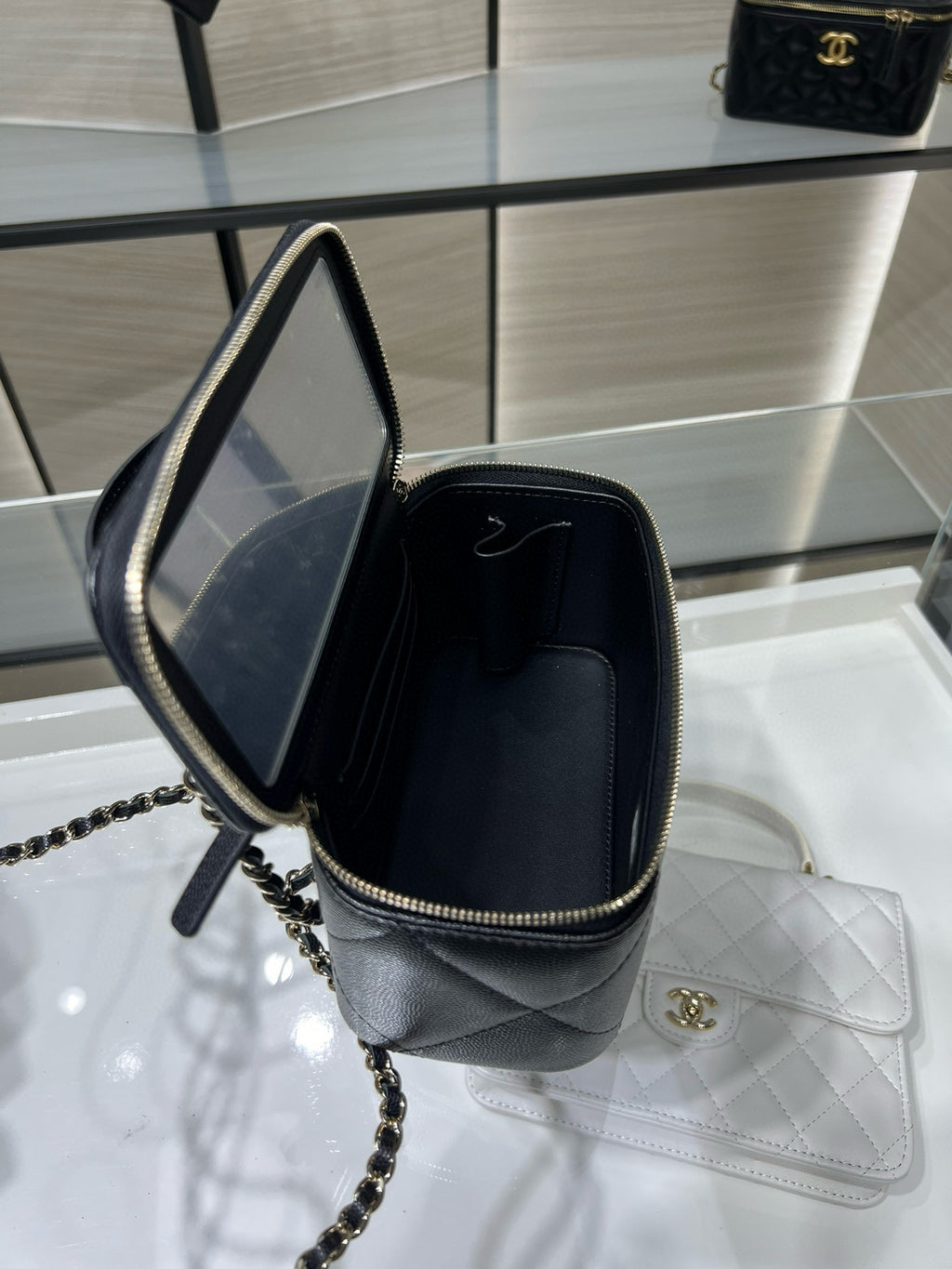 Chanel bag with open top and chain strap, dark interior, gold hardware and zipper