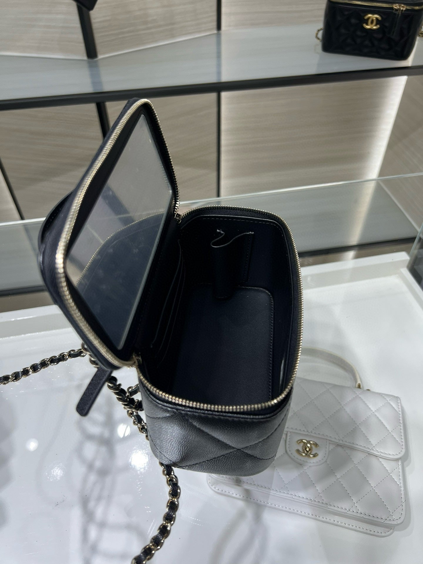 Chanel bag with open top and chain strap, dark interior, gold hardware and zipper