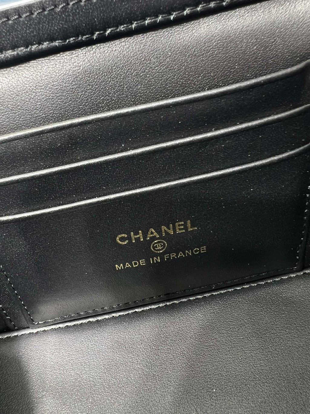 Chanel bag interior label reading 'CHANEL MADE IN FRANCE' on dark leather