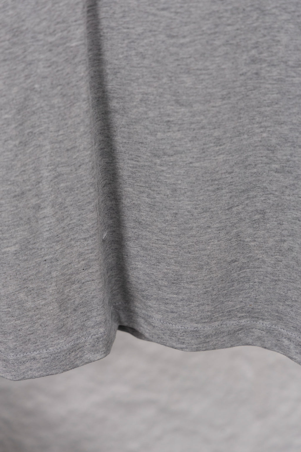 Dior long-sleeve crewneck top hem and side view in heather gray jersey knit