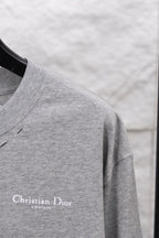 Dior long-sleeve crewneck top close-up on sleeve and shoulder seam, heather gray