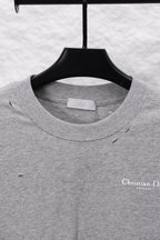 Dior long-sleeve crewneck top on hanger; heather gray with small chest logo