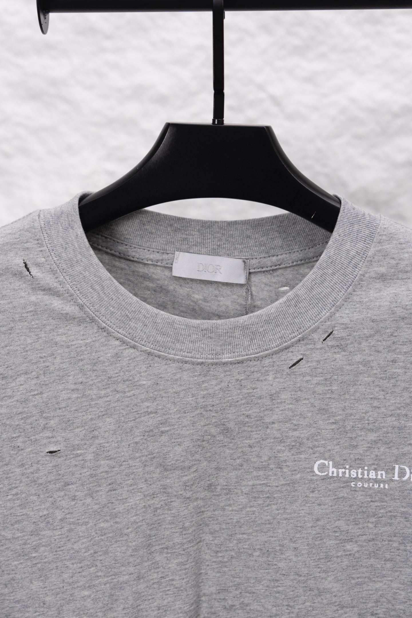 Dior long-sleeve crewneck top on hanger; heather gray with small chest logo