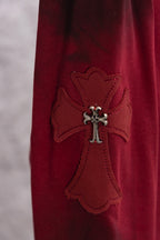 Red long-sleeve shirt with appliqued cross emblem featuring small silver detail