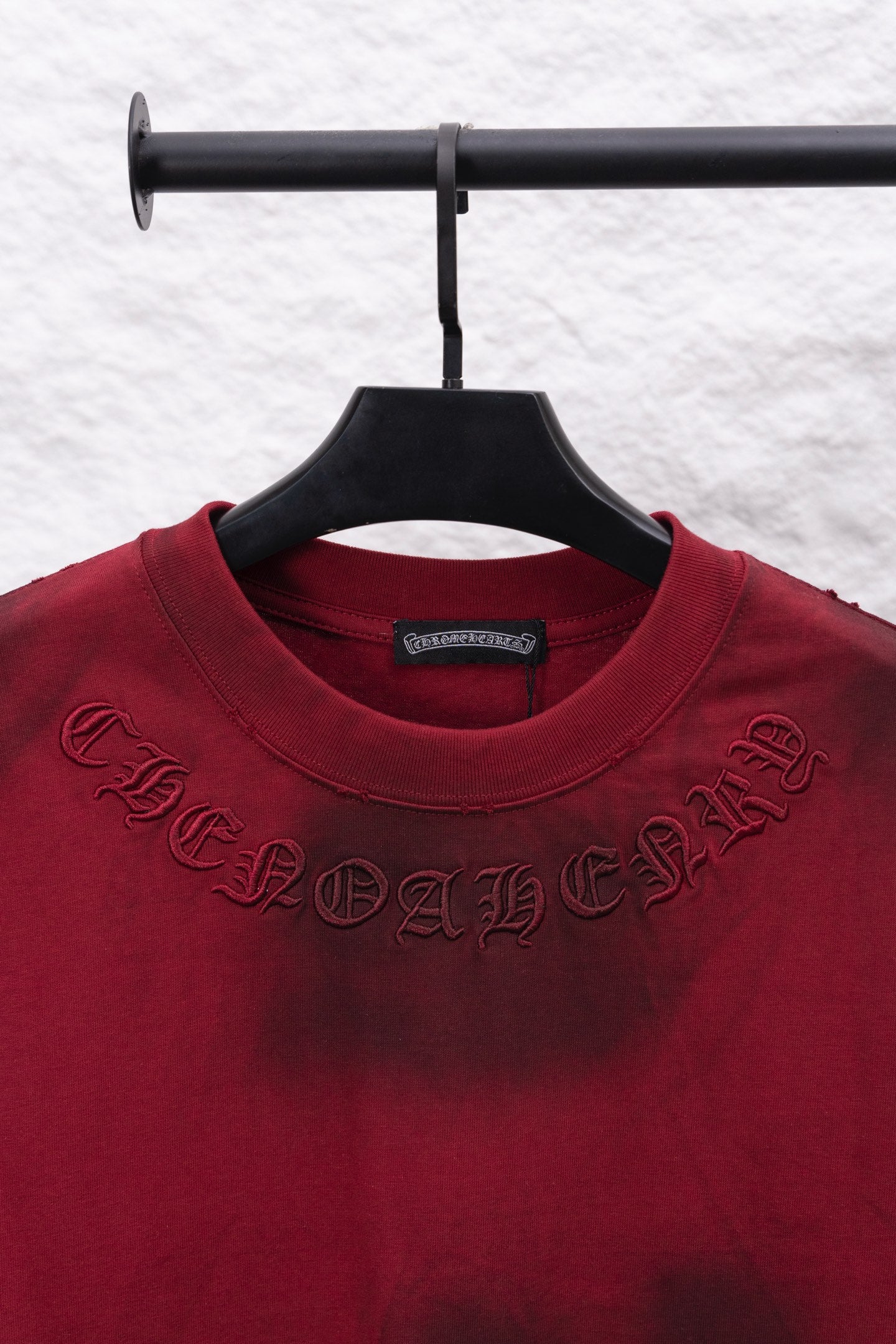 Red long-sleeve T-shirt with embroidered logo on chest and crew neck