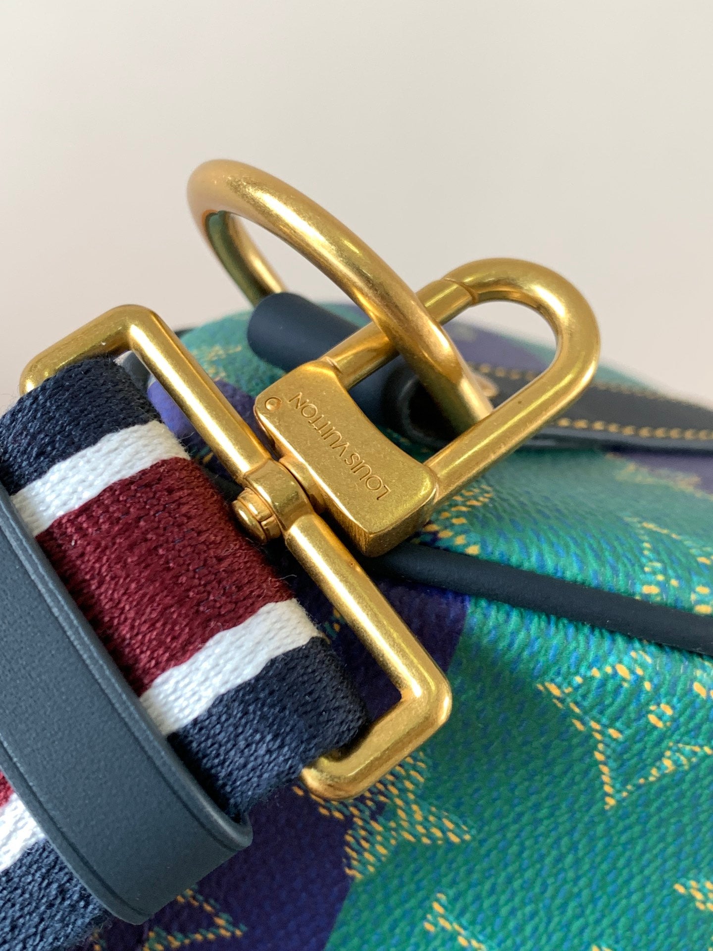 Louis Vuitton multicolor bag clasp with gold hardware and striped strap