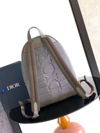 Light gray Dior men's backpack open view showing interior lining and adjustable straps
