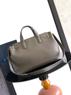 Dior handbag with top handles and long shoulder strap, light gray leather