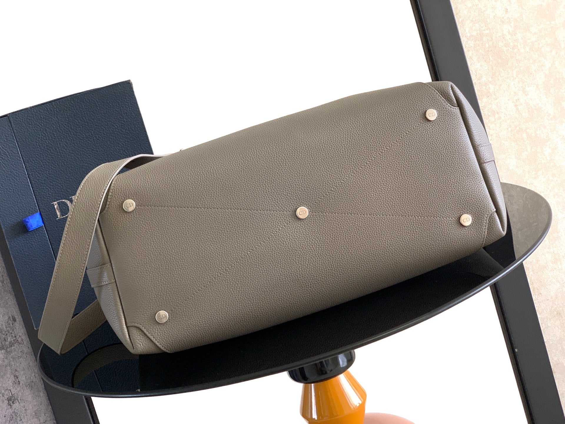Dior men’s light gray leather duffle-style bag with snap top flap and metal studs