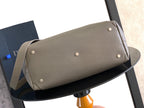 Dior handbag with magnetic flap and metal studs, light gray leather