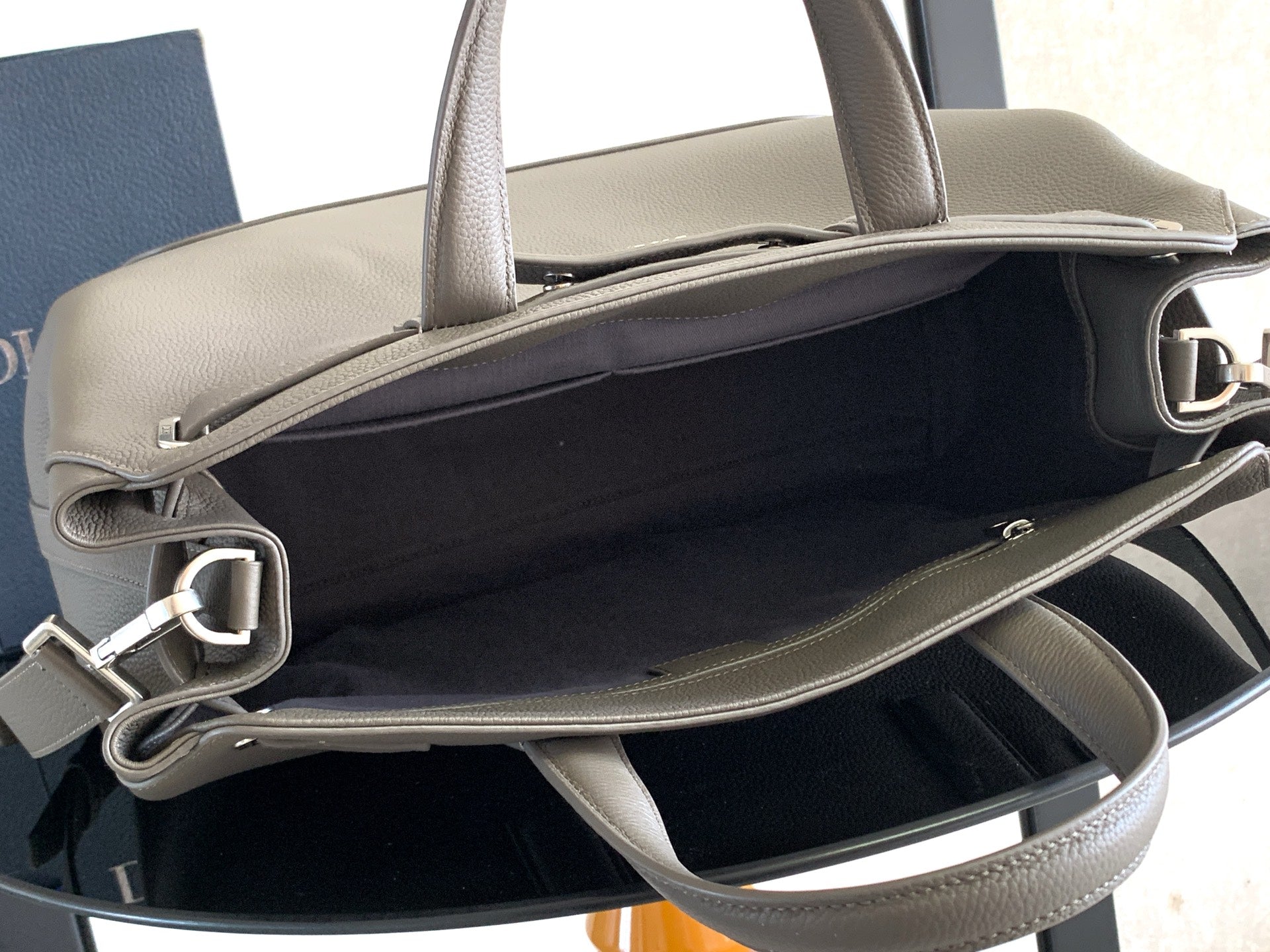 Dior men’s light gray leather bag open top with interior lining and side strap rings