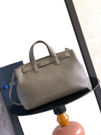 Dior men’s light gray leather tote bag with two top handles and front strap accents