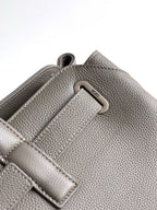 Dior men’s light gray leather bag close-up of metal D-ring and strap detail