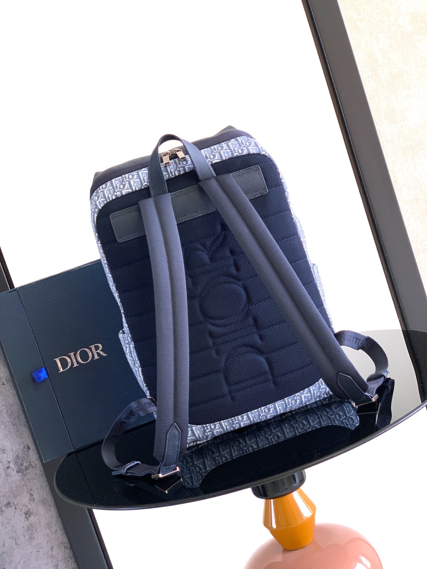 Men's Dior crossbody bag with blue quilted sides, adjustable strap and zip closure