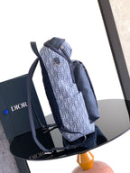 Men's Dior crossbody bag with blue monogram print, dual top straps and zip closure