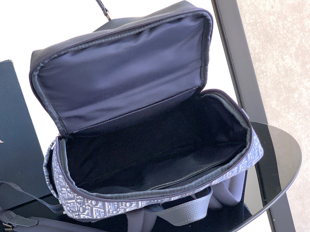 Dior mini bag open view with blue monogram exterior and dark interior