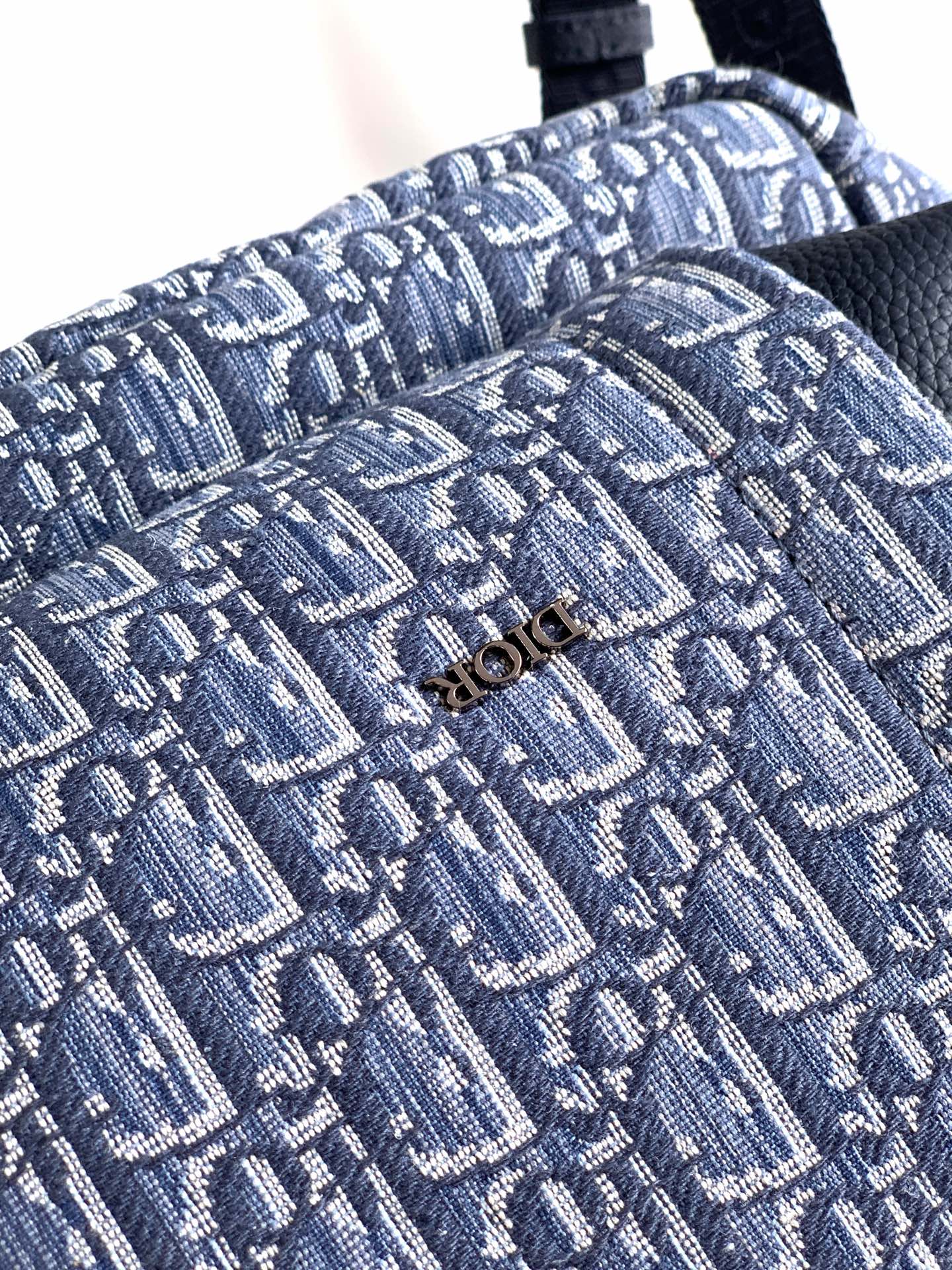 Dior monogram fabric detail on blue mini bag, textured woven pattern