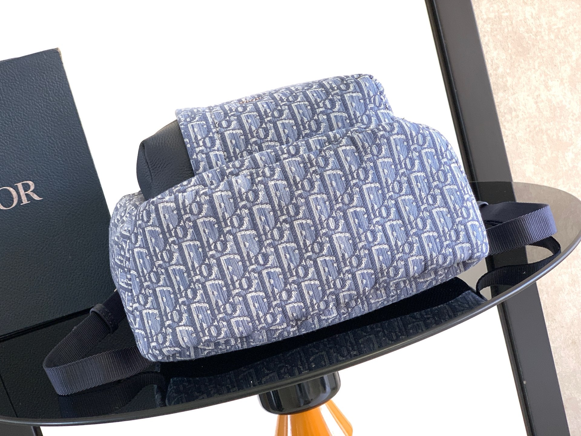 Men's Dior crossbody bag with blue Dior monogram print and dark top strap