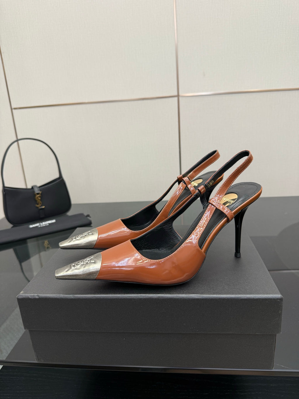 Women’s high-heel pump in orange patent with black cutouts and silver pointed toe tips