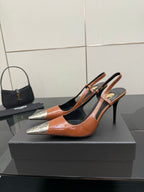 Women’s high-heel pump in orange patent with black cutouts and silver pointed toe tips
