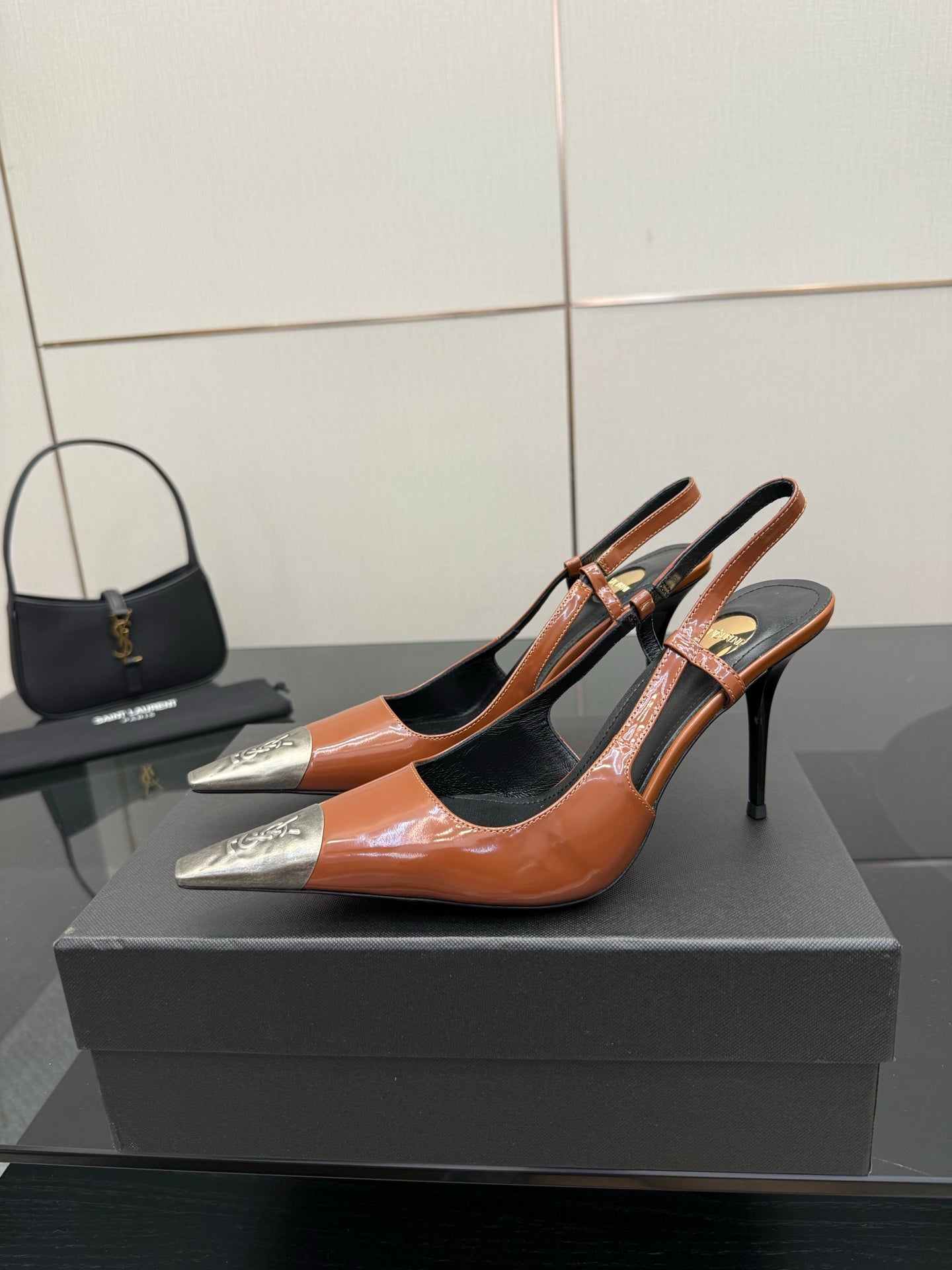Women’s high-heel pump in orange patent with black cutouts and silver pointed toe tips