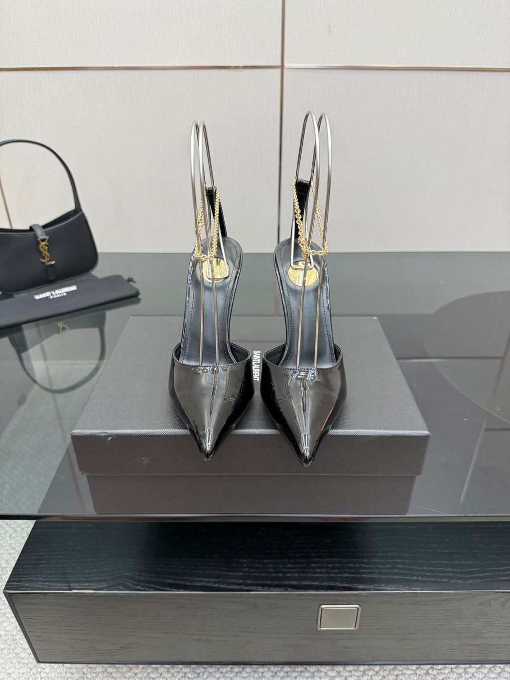 Women’s silver patent leather pointed-toe stiletto heels with gold chain detailing