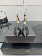 Women’s silver patent leather pointed-toe stiletto heels with gold chain detailing
