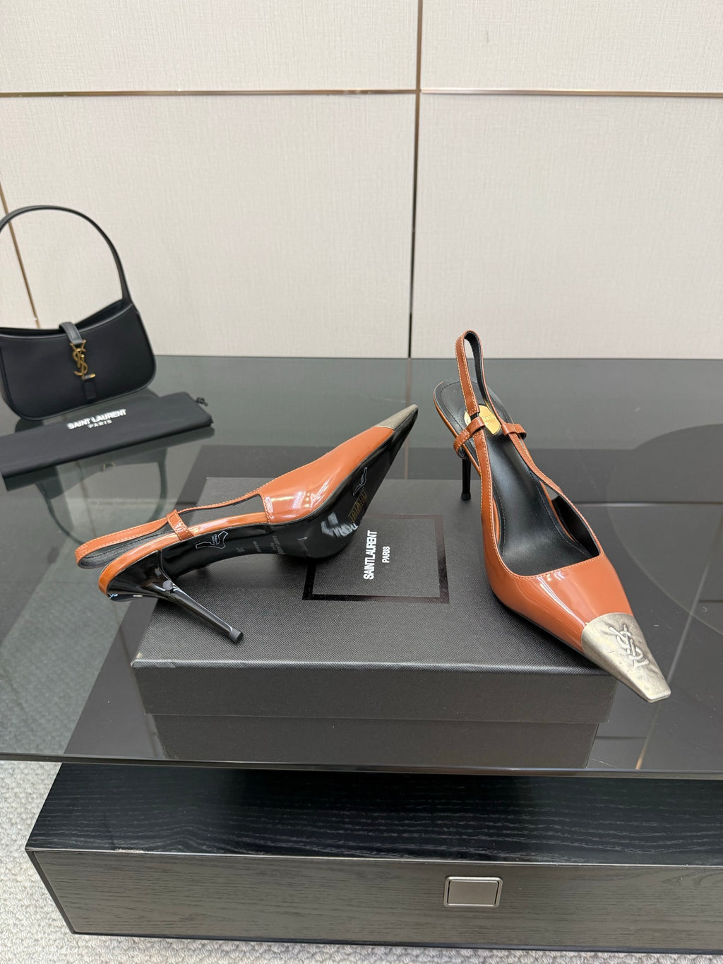 Women’s high-heel slingback pumps with orange patent finish, black accents, silver toe tips