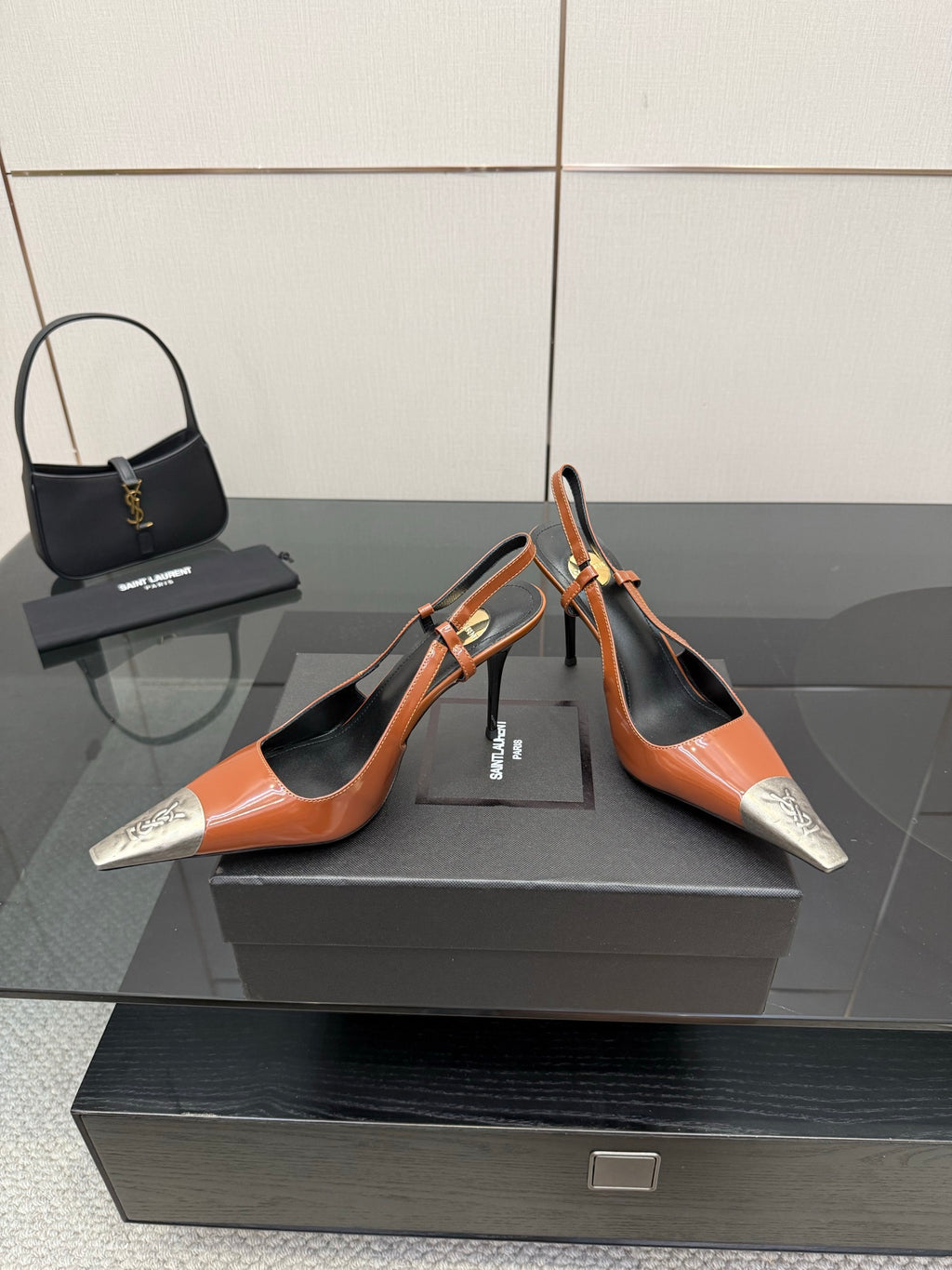 Women’s orange patent high-heel pumps with black trim and silver pointed toe details