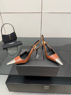 Women’s orange patent high-heel pumps with black trim and silver pointed toe details