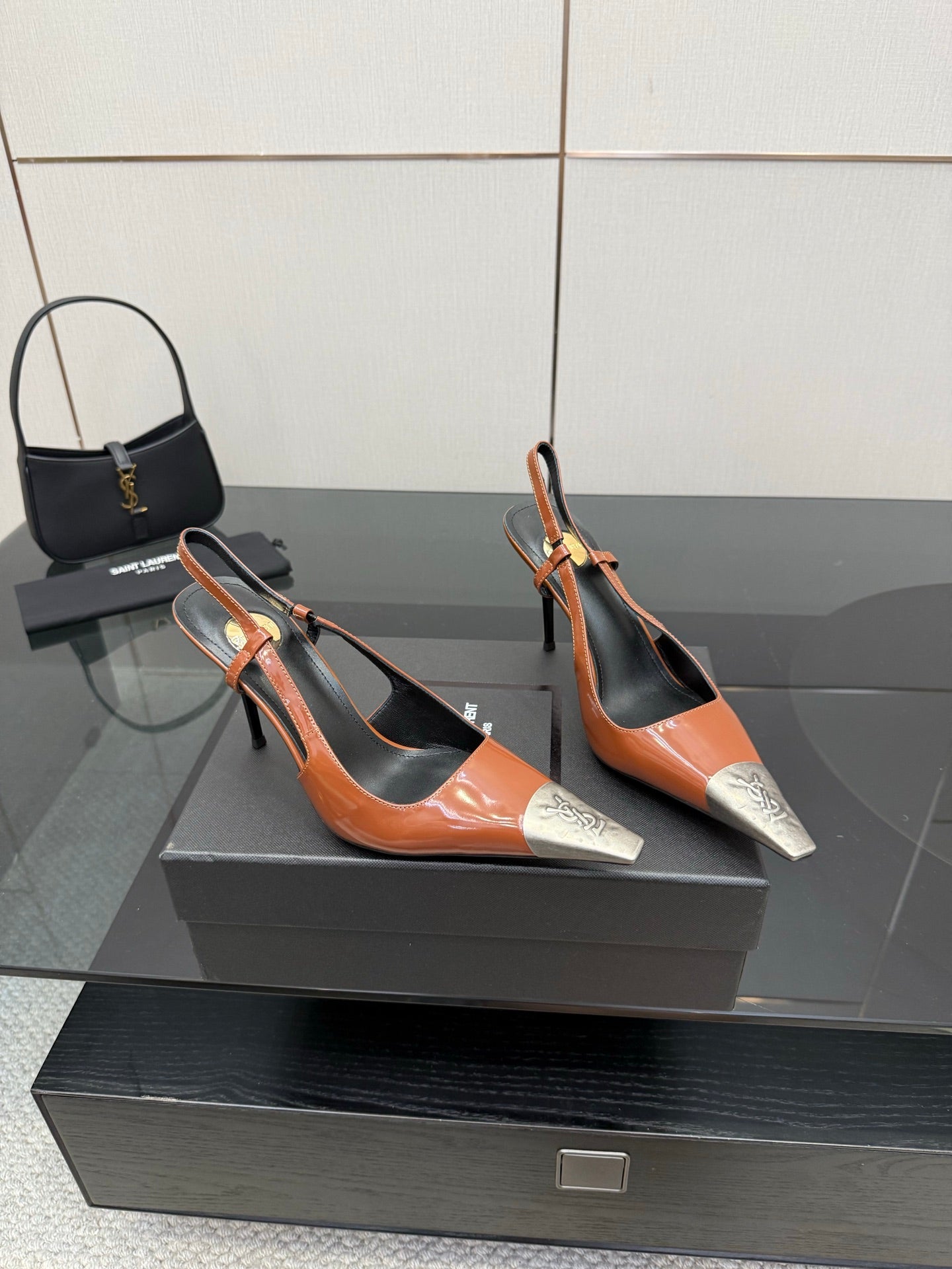 Women’s high-heel slingback pumps in orange patent with black panels and silver toe tips