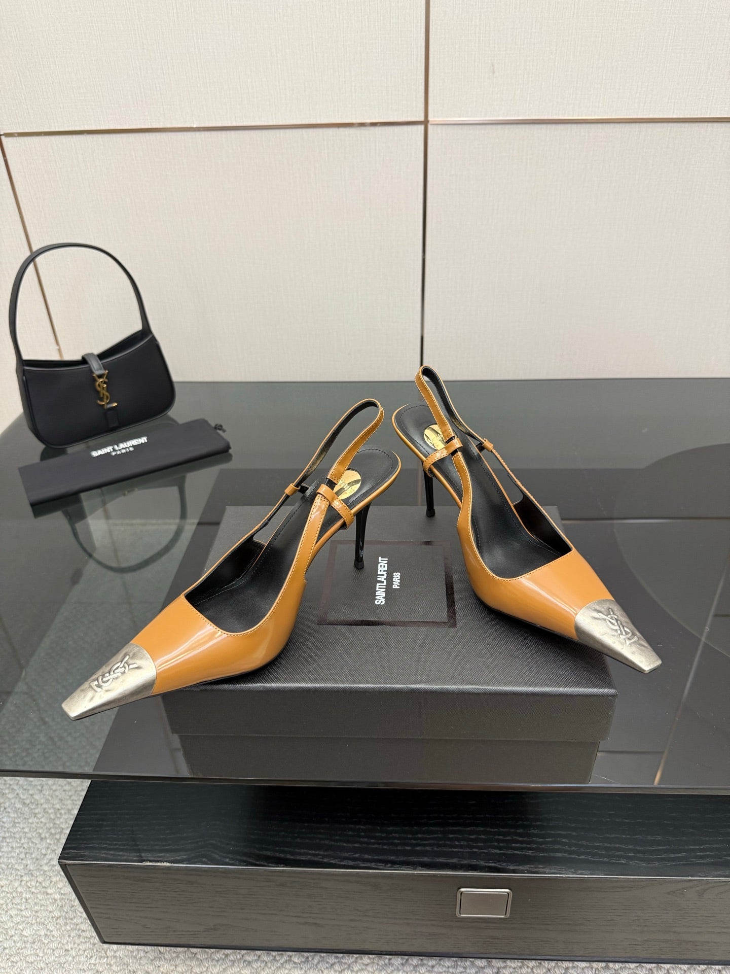 YSL womens pumps with tan uppers and black footbed, silver front toe accents