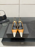 YSL womens heels with tan upper, black slingback, and silver pointed toe caps