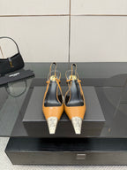 YSL womens heels with tan upper, black slingback, and silver pointed toe caps