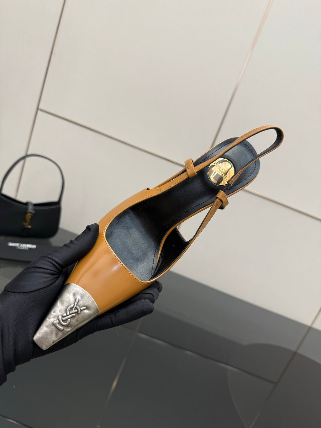 YSL womens slingback heels close-up with tan leather, black insole, and silver toe cap